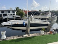 a boat docked at a dock in front of a house