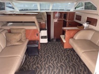 the interior of a boat with leather seats and tan carpet