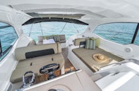 the interior of a boat with a sofa and chairs
