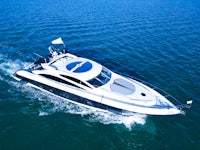 a white motor boat is traveling in the water