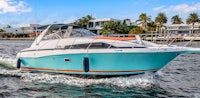 a blue and white motor boat is traveling in the water