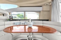 the interior of a boat with white couches and a table