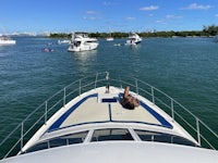 a person is laying on the back of a boat in the water