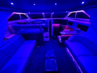 the interior of a boat is lit up with blue lights