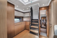 the interior of a boat with a wooden staircase
