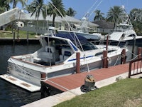 a boat docked at a dock in front of a house