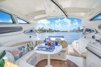 the interior of a boat with a table and chairs