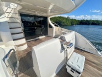 a white boat with a cooler on the deck