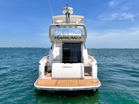 a white boat in the water with a blue sky