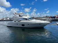 a white motor yacht is docked in the water