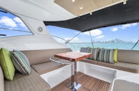 the interior of a boat with couches and a view of the city