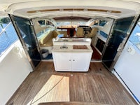 the interior of a boat with a kitchen and dining area