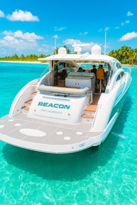 a white motor boat is floating in the water