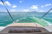 a view from the back of a boat with a view of the city