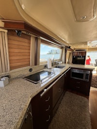 the interior of a motor home with a stove and sink