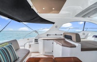 the interior of a boat with a sofa and chairs