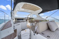 the interior of a sailboat with a sofa and chairs