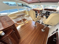 the interior of a motor yacht with wooden floors