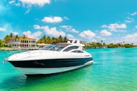 a white and black boat is floating in the water