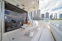 a white boat with a table and chairs in the middle of the water