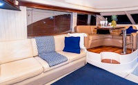 the interior of a boat with a couch and tv