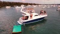 a group of people standing on a boat in the water