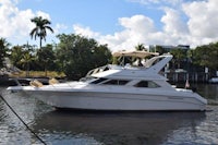 a white motor boat is docked in the water