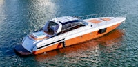 an orange and white motor boat is floating in the water