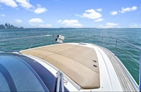 a view from the back of a boat with a city in the background