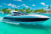 a black and white motor boat is traveling in the water