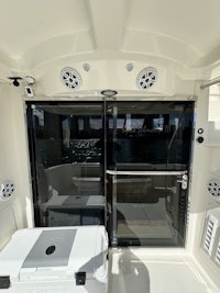 the inside of a boat with a cooler in it