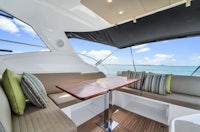 the interior of a motor yacht with couches and a table