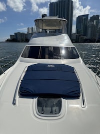 the bow of a white motor yacht in the water