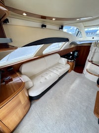 the interior of a motor yacht with a couch and tv