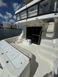 the back of a white boat with a door on the side