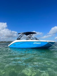 a blue and white boat is floating in the water