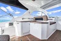the interior of a boat with a sofa and a table