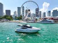 a boat in the water near a ferris wheel