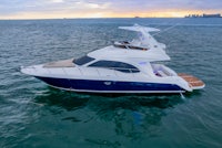 a white and blue motor yacht in the ocean