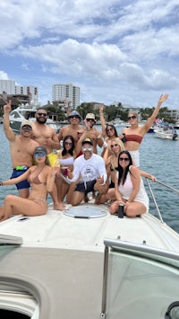 a group of people on a boat posing for a photo