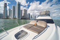 a white boat with a view of a city in the background