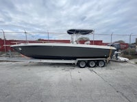 a boat is parked on a trailer in a parking lot