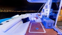 the deck of a boat at night with blue lights