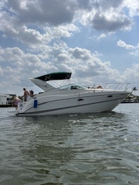 a white motor boat on the water with people on it