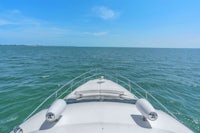 the view from the bow of a boat in the ocean