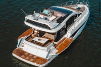 a motor yacht with two people on the top deck