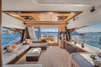 the interior of a luxury yacht with couches and a dining table