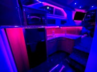 the interior of a boat is lit up with purple lights