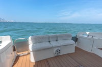 a white couch on the deck of a boat