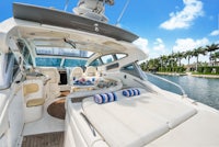 the back of a white boat with a view of the water